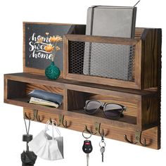 a wooden shelf with keys, sunglasses and other items hanging on it's sides