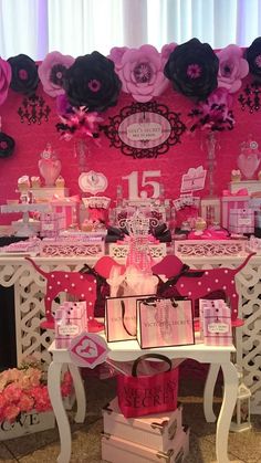 a table with pink and black decorations on it's sides, along with other items