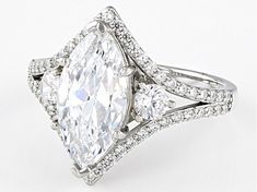 an oval cut diamond ring with double halos and pave diamonds on the sides