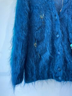 Vintage Alain Murati Ocean Blue Fuzzy Sweater Cardigan. Absolutely stunning ocean blue sweater with two toned teal and blue embroidery designs. Floral designs scatter across the front with a big personality. Inner lining has subtle impressions that only adds to the charm of this statement piece. In excellent vintage condition. Mohair blend. Unmarked size, material is stretchy. Fits a M/L . Hand wash cold. Approx. Measurements: Length: 26" Underarm to underarm: Up to 30" Elegant Blue Winter Sweater, Embroidered Blue Sweater For Fall, Blue Embroidered Sweater For Fall, Blue Embroidered Long Sleeve Sweater, Elegant Blue Winter Cardigan, Blue Embroidered Winter Sweater, Embroidery Designs Floral, L Hand, Big Personality