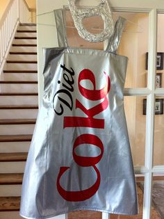 a coca cola bag hanging from the side of a stair case next to a door