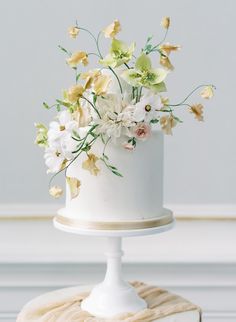 there is a white cake with flowers on it