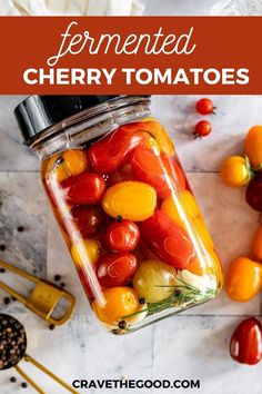 tomatoes and other vegetables in a jar with text overlay that reads fermeted cherry tomatoes