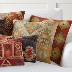 the pillows are all different colors and patterns