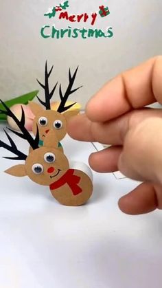 someone is making a paper reindeer ornament