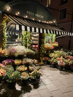 a flower shop with lots of flowers on display