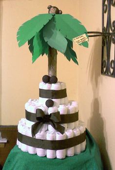 a cake made to look like a palm tree on top of toilet paper roll rolls