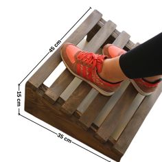 a person standing on top of a wooden pallet with their feet in the air