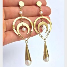 Bring Out Your Inner Goddess With These Dramatic Statement Earrings! Real Freshwater Pearls Paired With Lustrous Brass In An Antique Gold Hue Are In Perfect Harmony. Hand Wrapped Wire Details. Brass & Golden Stainless Steel Posts And Ear Backs. Approx. Size: 3-1/2"L, 1-1/8"W These Have An Antique Feel To Them. Similar To Anthropologie And Free People Style Jewelry. Anthro Style, Handmade Bohemian Earrings, Boho Jewelry, Chandelier Earrings New, Handcrafted By: Jpeace Designs White Metal Moon-shaped Jewelry, Elegant Brass Earrings With Moon Charm, Handmade White Pearl Earrings With Metal, Handmade White Metal Pearl Earrings, White Metal Moon Phase Jewelry, Elegant White Earrings With Moon Charm, Elegant White Moon Charm Earrings, Elegant White Crescent Earrings, White Pearl Drop Earrings In Brass