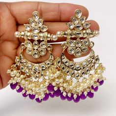 Bollywood Kundan Chaandbali Earrings/Indian Earrings/pearl Earring/Pakistani Earrings/Statement Earrings/Long chandelier/Indian wedding Length 3.3 inches Width 2.2 inches Arrives in a gift box Color, shades, texture displayed may slightly vary from the actual product due to digital image limitations. We request you to consider these minor variations. Please expect the possibility of some slight imperfections when buying handmade jewelry. If you have any questions, please contact us. Fusion Style Danglers With Dangling Beads For Weddings, Fusion Style Wedding Danglers With Beads, Wedding Fusion Danglers With Dangling Beads, Chandbali Earrings With Dangling Beads For Wedding, Wedding Chandbali Earrings With Dangling Beads, Wedding Earrings With Dangling Beads For Festivals, Festival Chandbali Pearl Earrings With Dangling Beads, Purple Earrings For Wedding And Festive Occasions, Festive Purple Earrings For Wedding