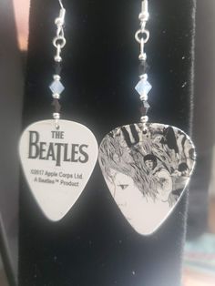 the beatles guitar pick earrings on display