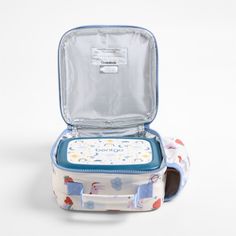 A fun and functional lunch box that's built to handle all the thrills and spills of the day. Sweet rainbow hearts, frolicking unicorns, flowers and strawberries decorate the lunch box's exterior, and a soft blue trim gives it the perfect finish. It's constructed of food-safe and supremely durable polyester fabric that includes recycled plastic bottles. It's also lightweight and easy to clean, plus roomy enough to hold multiple storage containers. An insulated lining keeps meals just the way your Playful Blue Lunch Box Gift, Playful Multicolor Lunch Box For Playtime, Playful Blue Lunch Box For Daycare, Playful Multicolor Lunch Box For Daycare, Blue Lunch Box For Back To School Gift, Rainbows And Unicorns, Kids Pencil Case, Unicorn Backpack, Backpack Gift