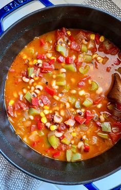 a pot filled with soup and vegetables on top of a stove