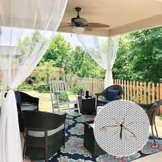 an outdoor living area with furniture and mosquito netting