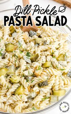 pasta salad in a glass bowl with dill pickles and parmesan cheese