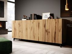 a large wooden cabinet sitting on top of a hard wood floor next to a green couch