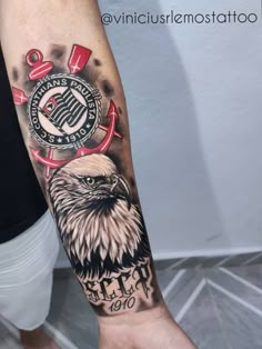 an eagle tattoo on the left arm and wrist with words, numbers and symbols around it