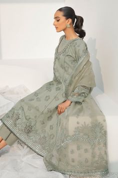 Pakistani Long Kameez Salwar and Dupatta Party Wear come in an Embellished Center Panel, Side Panels, Embroidered Sleeves, Embroidered Sleeves Border, Lace Neckline, Lace Patches for Slits, and Lace Borders. It is paired with Embroidered Net Dupatta, Embroidered Dupatta Length Border, and Embroidered Dupatta Pallu Border, it has Plain Dyed Back, paired with Plain Dyed Trousers. Detailed Description: SKU: PB0023 Detailing: Embroidery, Threads, Floral designs Color: Grey Fabric: Jacquard Design: F Long Kameez, Pakistani Boutique, Pakistani Designer Clothes, Border Lace, Eid Dresses, Jacquard Design, Pakistan Fashion, Embroidery Threads, Embroidered Sleeves