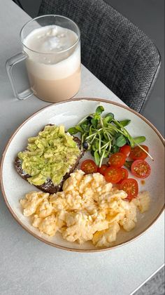 a white plate topped with food next to a glass of milk