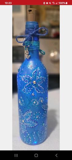 a blue glass bottle sitting on top of a table