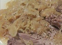 meat and noodles in a white bowl with seasoning on top, ready to be eaten