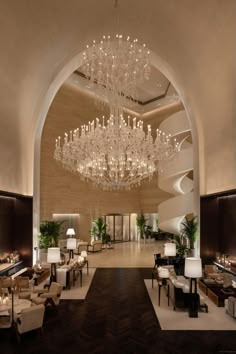 an elegant lobby with chandeliers and seating