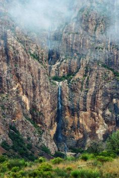 there is a waterfall in the middle of this mountain