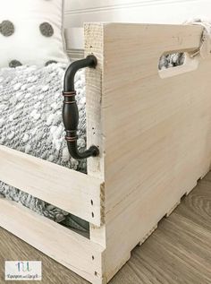 a bed frame with an exposed pipe on the bottom and side is made out of wood