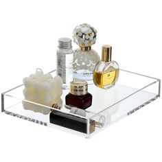 an acrylic tray with perfume bottles and other items