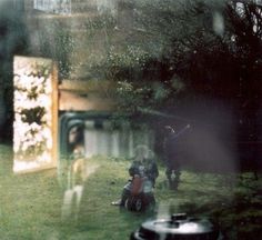 two children are playing in the yard with their lawn mowers and other toys