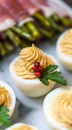 an image of deviled eggs with whipped cream and holly leaves on them for christmas