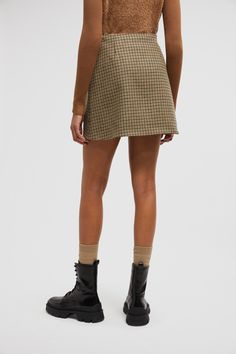 Taking inspiration from sartorial styles, this mini skirt is crafted from checked wool. The design is featured in a timeless A-line silhouette. Chic Houndstooth Mini Skirt, Plaid Mini Skirt For Work, Elegant Plaid Mini Skirt For Work, Elegant Houndstooth Mini Skirt, Houndstooth Mini Skirt For Work, Fall Workwear A-line Skort, Fall A-line Skort For Workwear, Wool Lined Mini Skirt, Wool Mini Skirt For Fall