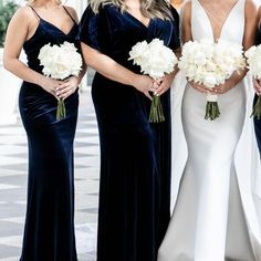 the bridesmaids are all dressed in black and white gowns with their bouquets