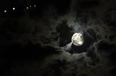 the moon is shining brightly in the night sky