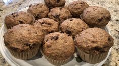 a white plate topped with muffins on top of a counter