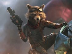 the rocket raccoon is holding an object in his hand