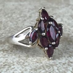 Garnet Cluster Ring Sz 7/Sterling Silver/Genuine 5.4ct Marquise Cut/Rhodolite Garnet/Signed/Pink Purple Garnet/Vintage Estate/Ring For Women Description Beautiful rhodolite garnet ring in excellent vintage condition. A total of 5.4ct of genuine, marquise cut garnet set in designer signed stamped 925 sterling silver setting. Face of ring measures 20mm from top to bottom and has a weight of 5.1g. Gorgeous pink purple color and fantastic sparkle! Size 7. All Gems tested with Presidium Gem Tester. A Silver Marquise Ruby Ring, Purple Garnet, Garnet Ring Vintage, Garnet Wedding, Rhodolite Garnet Ring, Star Garnet, Estate Ring, Garnet Gem, Estate Rings