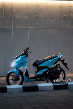 a blue scooter is parked on the street