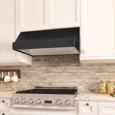 a stove top oven sitting inside of a kitchen next to white cabinets and counter tops