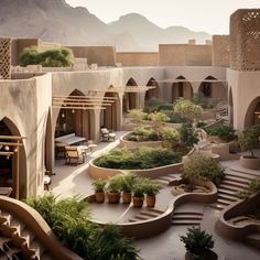 an outdoor courtyard with steps and plants in the middle, surrounded by buildings that have mountains in the background