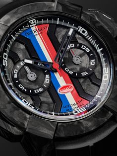 Jacob & Co.'s limited edition 'Epic X' timepiece commemorates 110 years since Bugatti's founding, so it's packed with plenty of sporty references. Crafted with a robust titanium and carbon fibre case that takes its cues from the body of the anniversary Chiron, the dial offers a range of timekeeping functions and is etched with the French flag at the centre while the car manufacturer's logo sits at the 6 o'clock position. You can view the impressive Swiss-made calibre JCAA05 automatic movement t… Luxury Chronograph Watch With Stopwatch, Luxury Black Chronograph Watch With Stopwatch, Bamford Watch, French Flag, Automatic Watches For Men, Latest Watches, Rubber Watches, Cycling Accessories, Branded Gifts