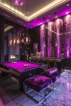 a purple pool table in a room with chandeliers and lights on the walls