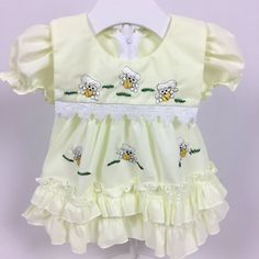 Yellow dress with embroidered poodles. Ruffle trim. Zipper on back. Tag says size: 2 but looks around 0-6 months. Check measurements below for fit.  Measurements (approximate): Shoulder to Hem: 14" Armpit to Armpit: 10" Brand: Minh Hanh Be sure to check out my shop! New items added often! https://www.etsy.com/shop/AutumnRoseArtVintage Cute Dresses With Embroidered Hem And Short Sleeves, Cute Short Sleeve Dress With Embroidered Hem, Fitted Cotton Dress With Machine Embroidery, Embroidered Cotton Dress With Doll Collar, Cotton Dresses With Machine Embroidery And Short Sleeves, Cotton Embroidered Dress With Doll Collar, Fitted Cotton Dresses With Picot Trim, Fitted Cotton Dress With Picot Trim, Cotton Dresses With Ruffles And Doll Collar