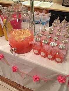 a table topped with lots of bottles filled with liquid and orange slices next to each other