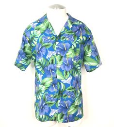 For sale is a lightly used 1970's vintage Hilo Hattie floral casual short sleeve  Hawaiian Aloha button down lightweight shirt.  100% Polyester Lightweight Original Blue Fish Eye Buttons Hibiscus, Monstera Leaf & Palm Tree Leaf Pattern Cuban Collar Left Front Pocket Straight Yoke With Side Pleats Colors In Blue, Yellow, Purple, Green & White Straight Hemline Tag Size: Extra Large(Vintage) Measurements in inches. Chest:  48 Waist:  47 Shoulder:  19 1/2 Length:  29 1/2 Will be shipped via USPS Fir Cheap Green Cotton Hawaiian Shirt, Green Hibiscus, Palm Tree Leaves, Fish Eye, Blue Fish, Palm Tree Print, Aloha Shirt, Yellow Purple, Monstera Leaf