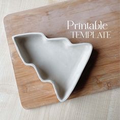 a white bowl sitting on top of a wooden cutting board