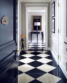 a hallway with black and white checkered flooring