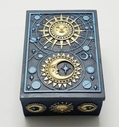 a decorative box with an image of the sun and moon on it