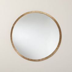 a round mirror hanging on the wall