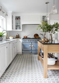 a kitchen filled with lots of white and blue appliances